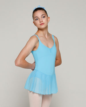 A person wearing a blue sleeveless leotard with a panel front and a short attached skirt.