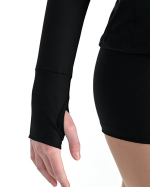 Young dancer wearing the Academy fitted zip front warm up dance jacket in Black, alternate view