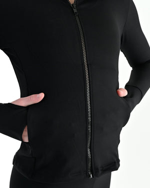 Young dancer wearing the Academy fitted zip front warm up dance jacket in Black, alternate view