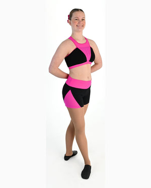 Young dancer wearing the Electra crossover racerback dance crop top in Electric Pink