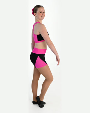 Young dancer wearing the Electra crossover racerback dance crop top in Electric Pink, alternate view