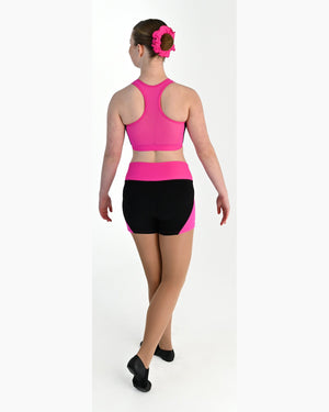 Young dancer wearing the Electra crossover racerback dance crop top in Electric Pink, alternate view
