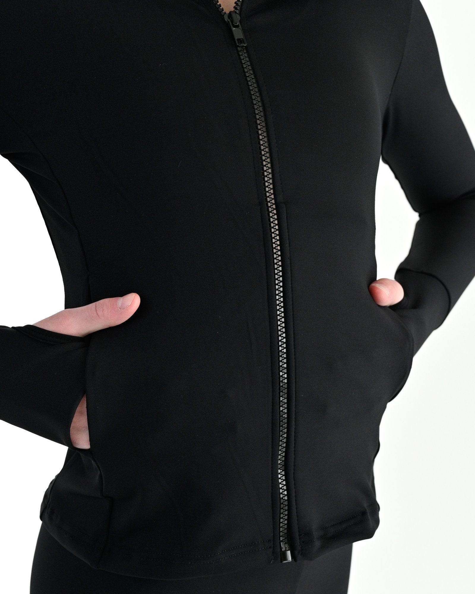 Young dancer wearing the Academy fitted zip front warm up dance jacket in Black, alternate view