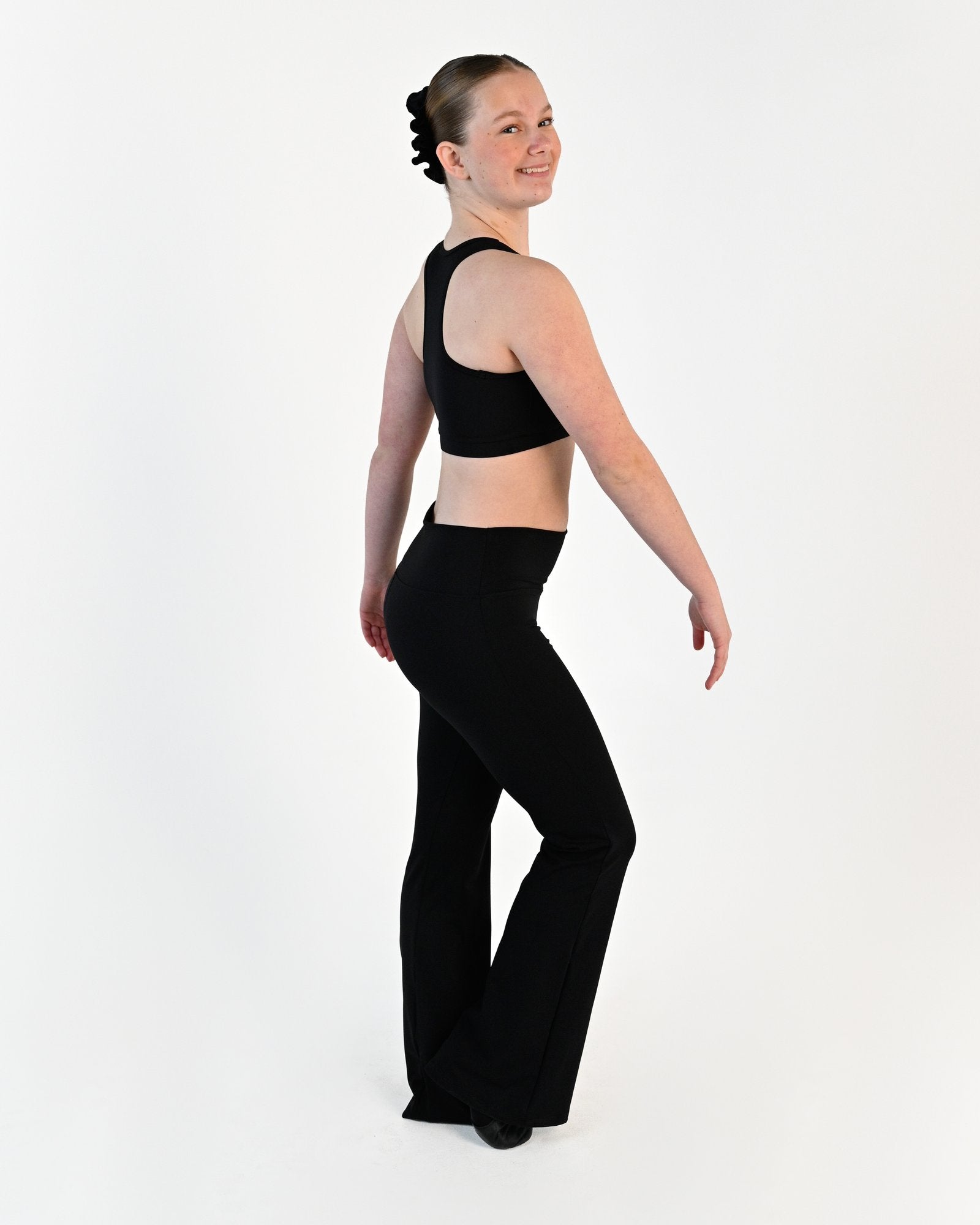 Young dancer wearing the Avery racerback dance crop top in Black, alternate view