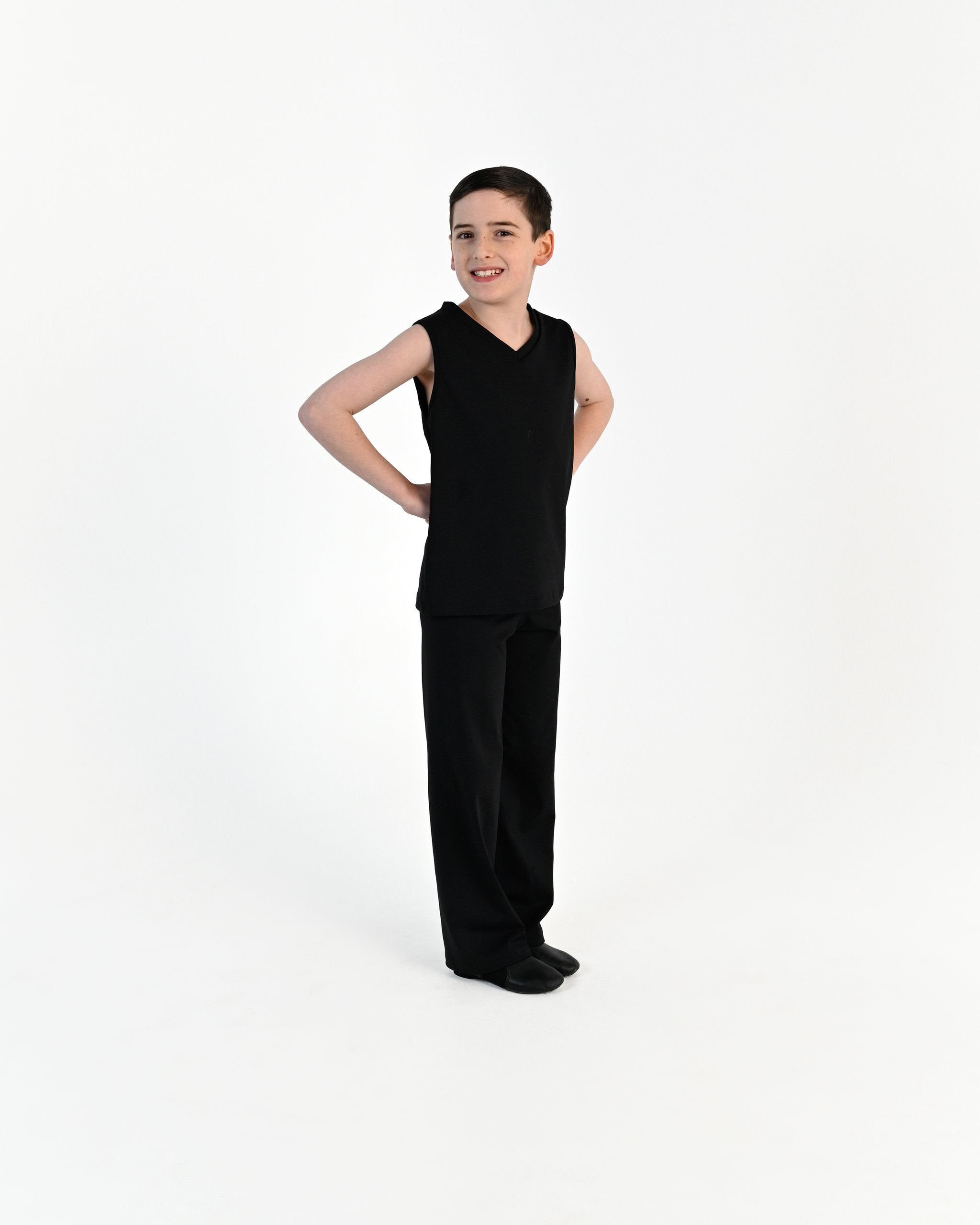 Young dancer wearing the Essential Boys Straight Leg Dance Pant in Black, alternate view