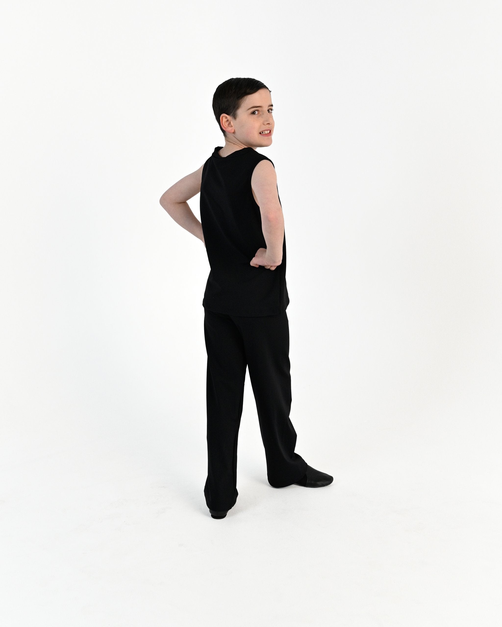 Young dancer wearing the Essential Boys Straight Leg Dance Pant in Black, alternate view