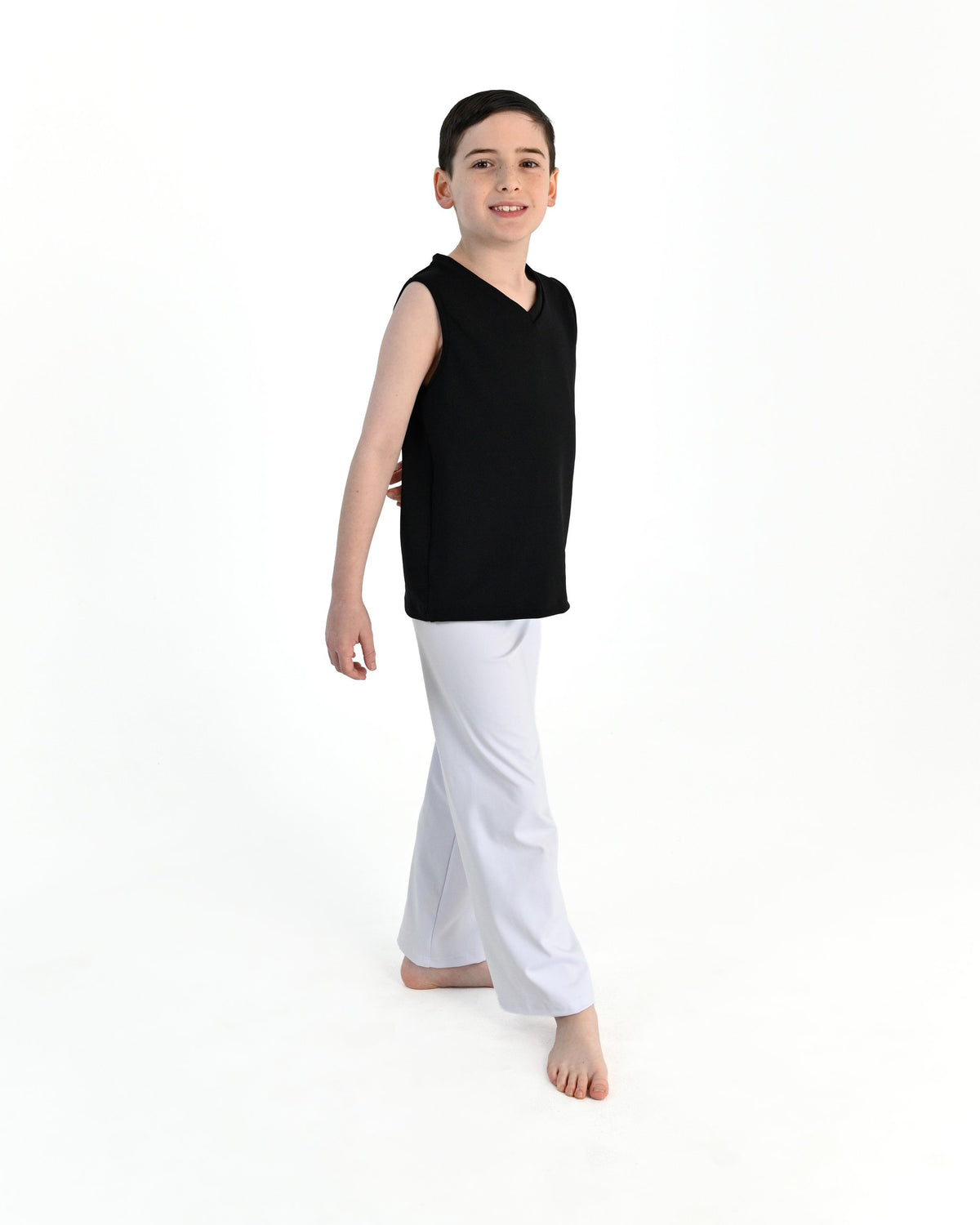 Young dancer wearing the Essential Boys Straight Leg Dance Pant in White