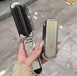 Total Dance foldable hair brush with removable mirror, metallic silver finish, palm-sized dance bag essential