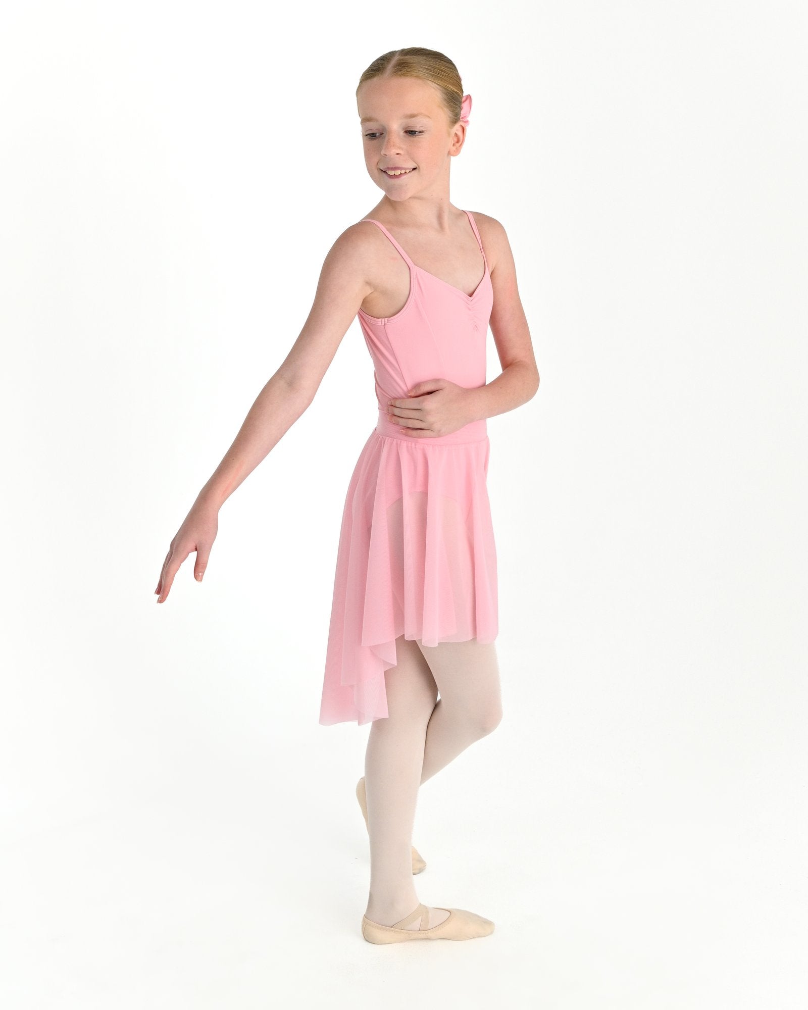 Young dancer wearing the Celeste high low stretch mesh ballet skirt in Pink