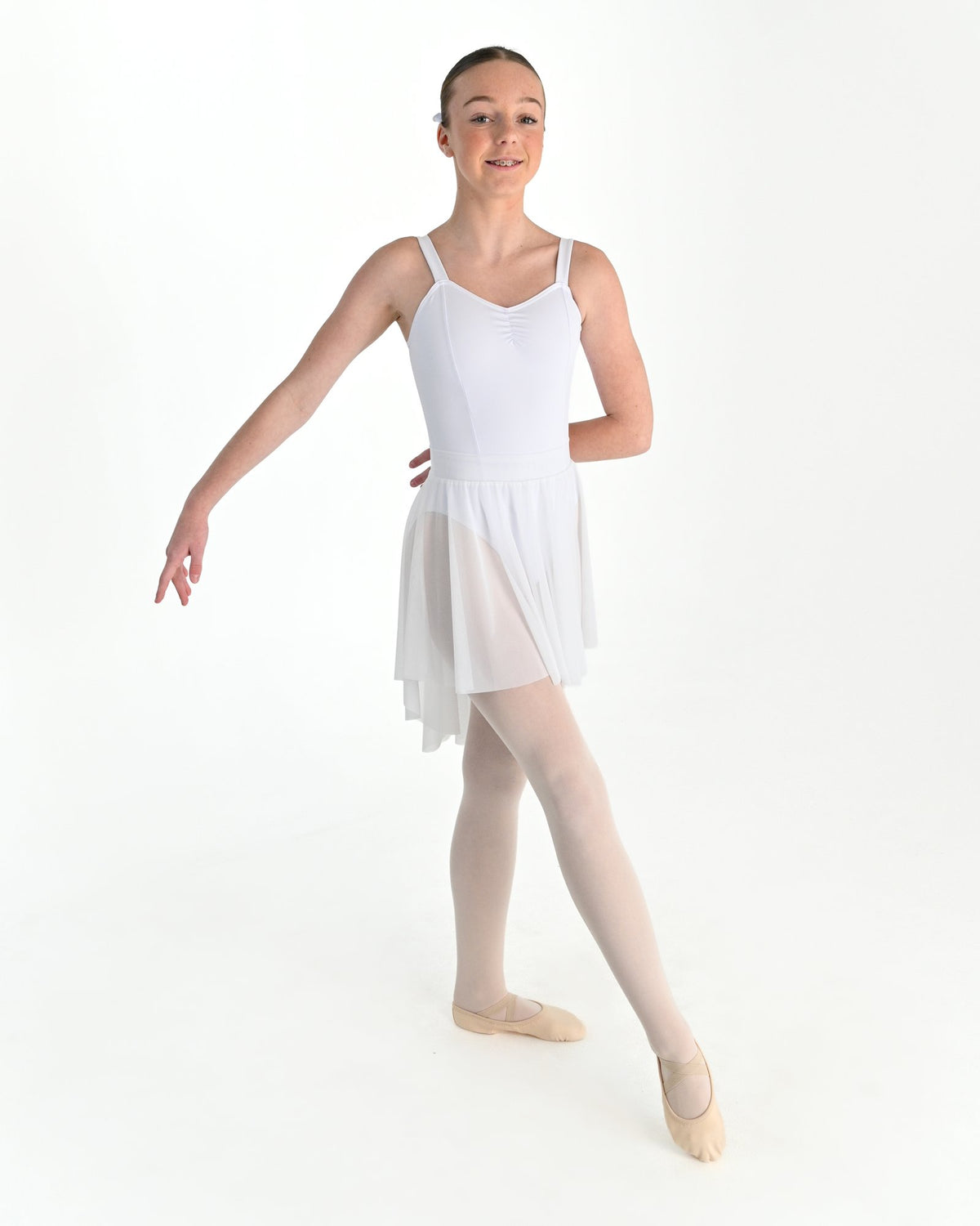 Young dancer wearing the Celeste high low stretch mesh ballet skirt in White