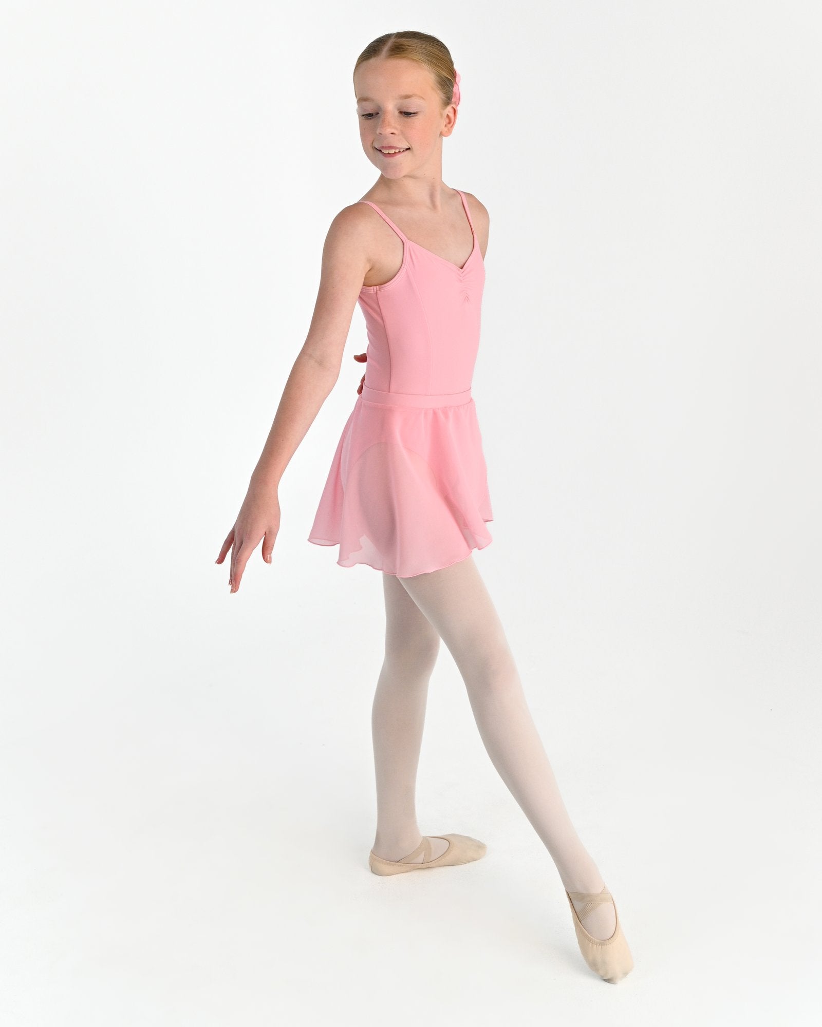 Young dancer wearing the Chiffon Pull-On Ballet Wrap Skirt in Pink