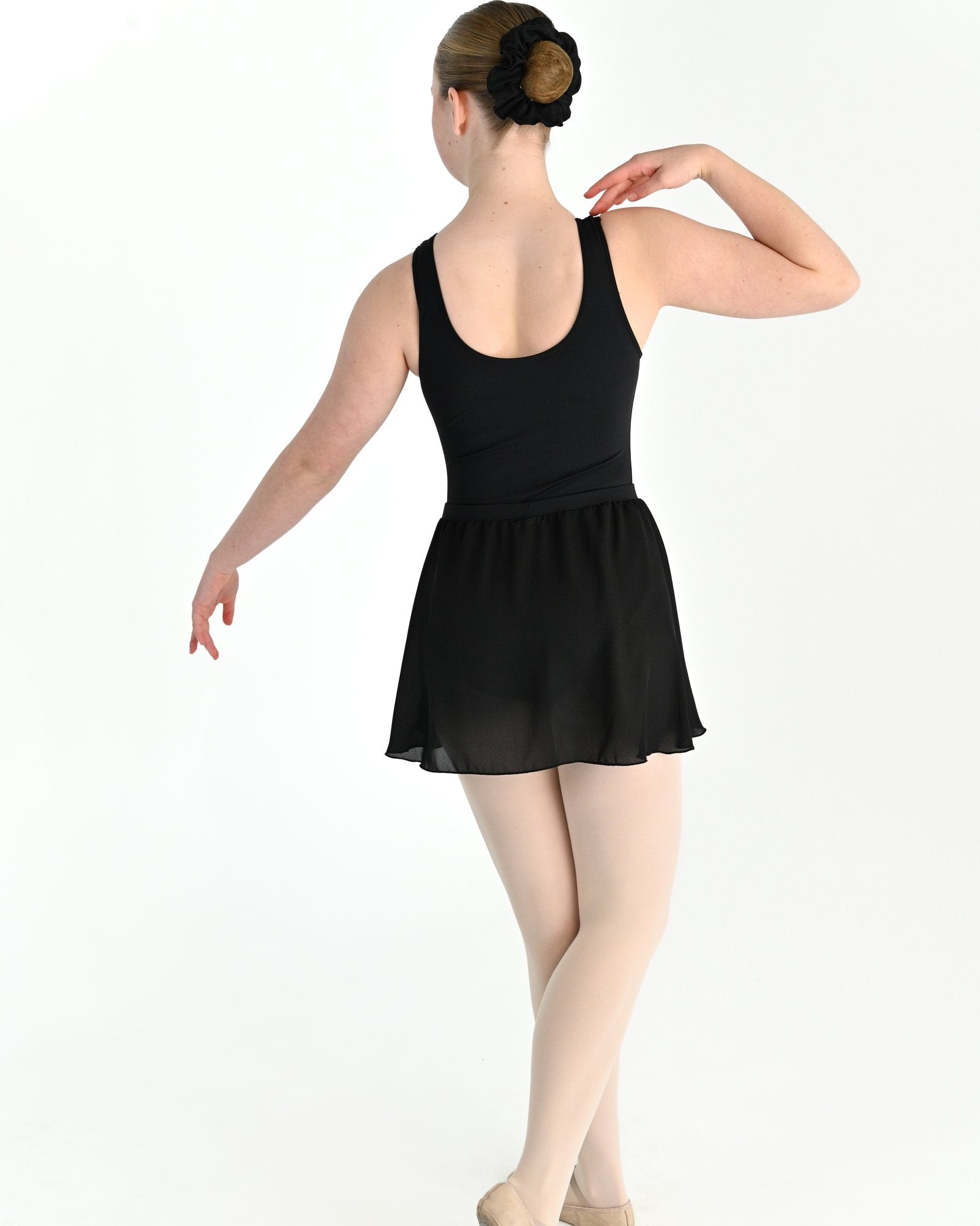 Young dancer wearing the Georgette Pull-On Ballet Wrap Skirt in Black, alternate view