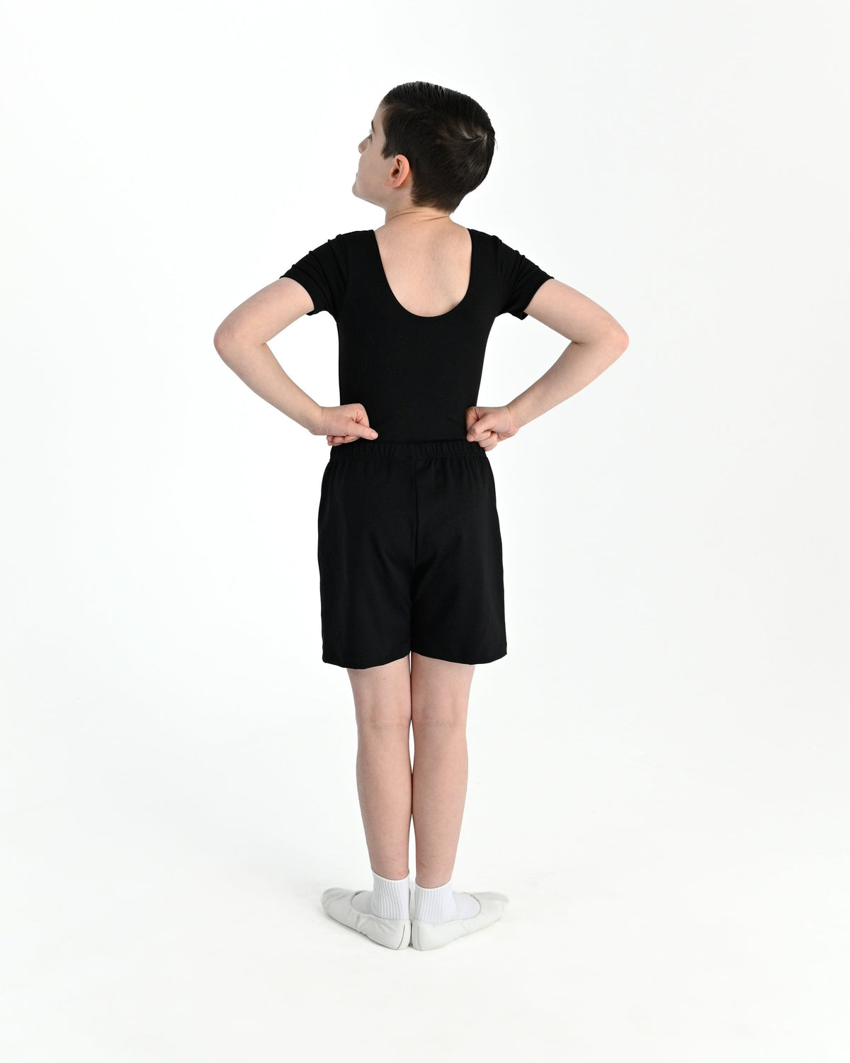 Young dancer wearing the Essential Boys Short Sleeve Leotard in Black, alternate view