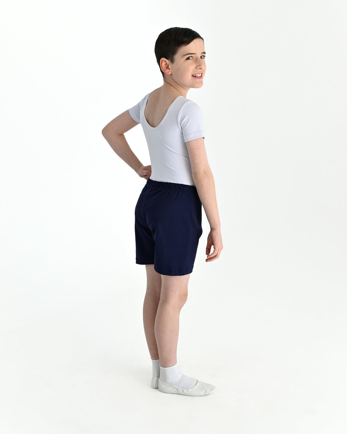 Young dancer wearing the Essential Boys Short Sleeve Leotard in White, alternate view