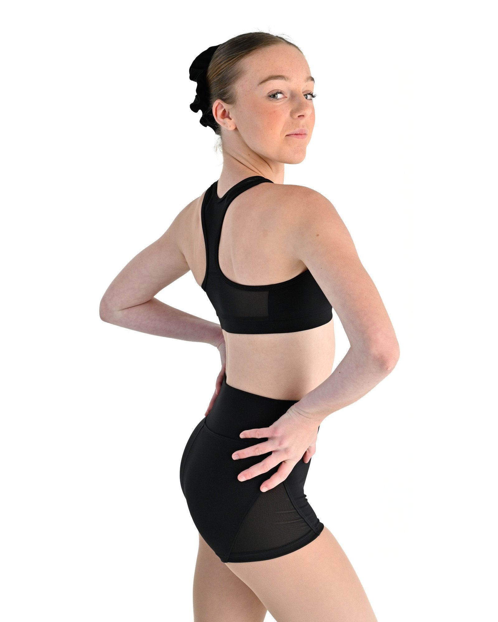 Young dancer wearing the Electra crossover racerback dance crop top in Black, alternate view