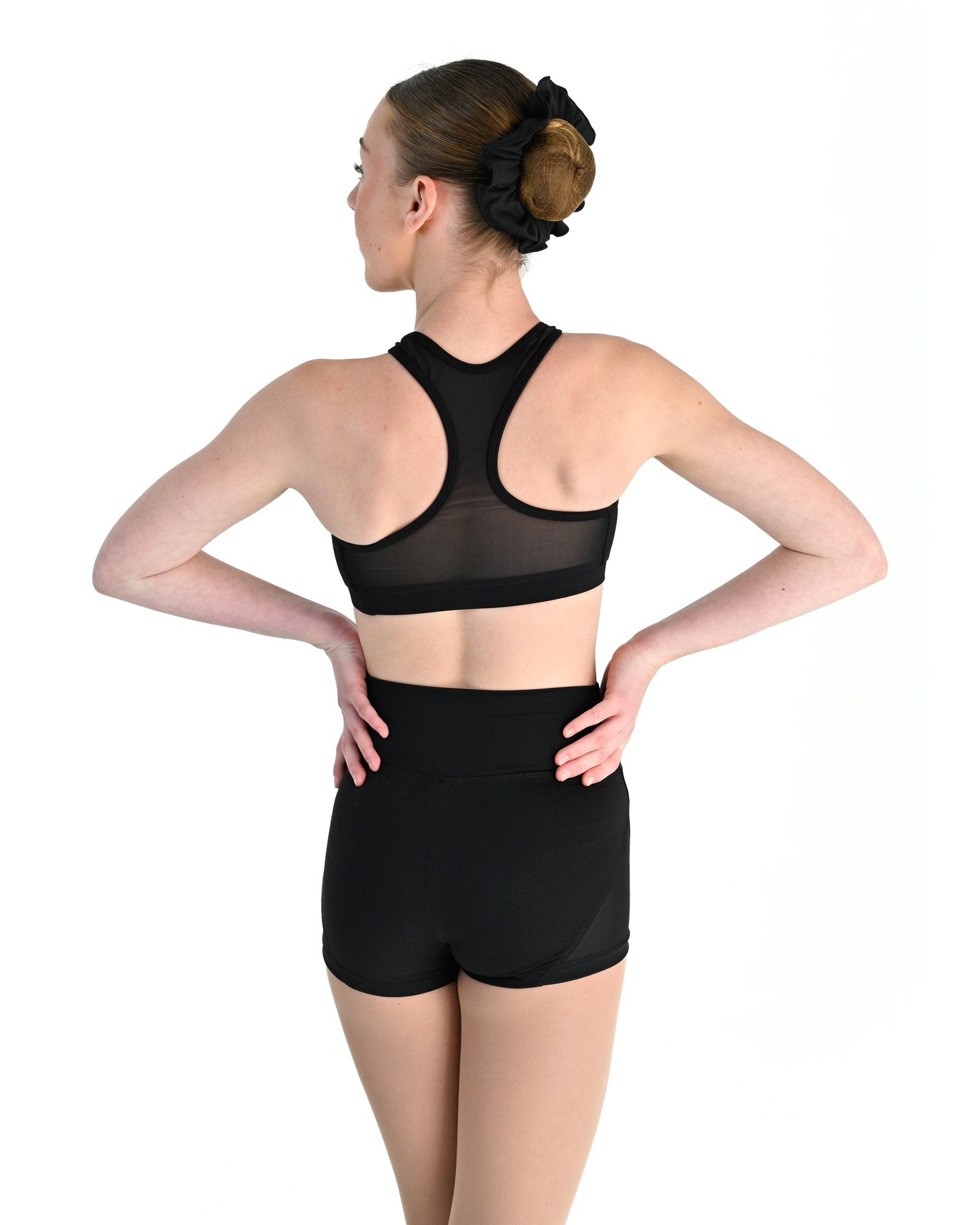 Young dancer wearing the Electra crossover racerback dance crop top in Black, alternate view