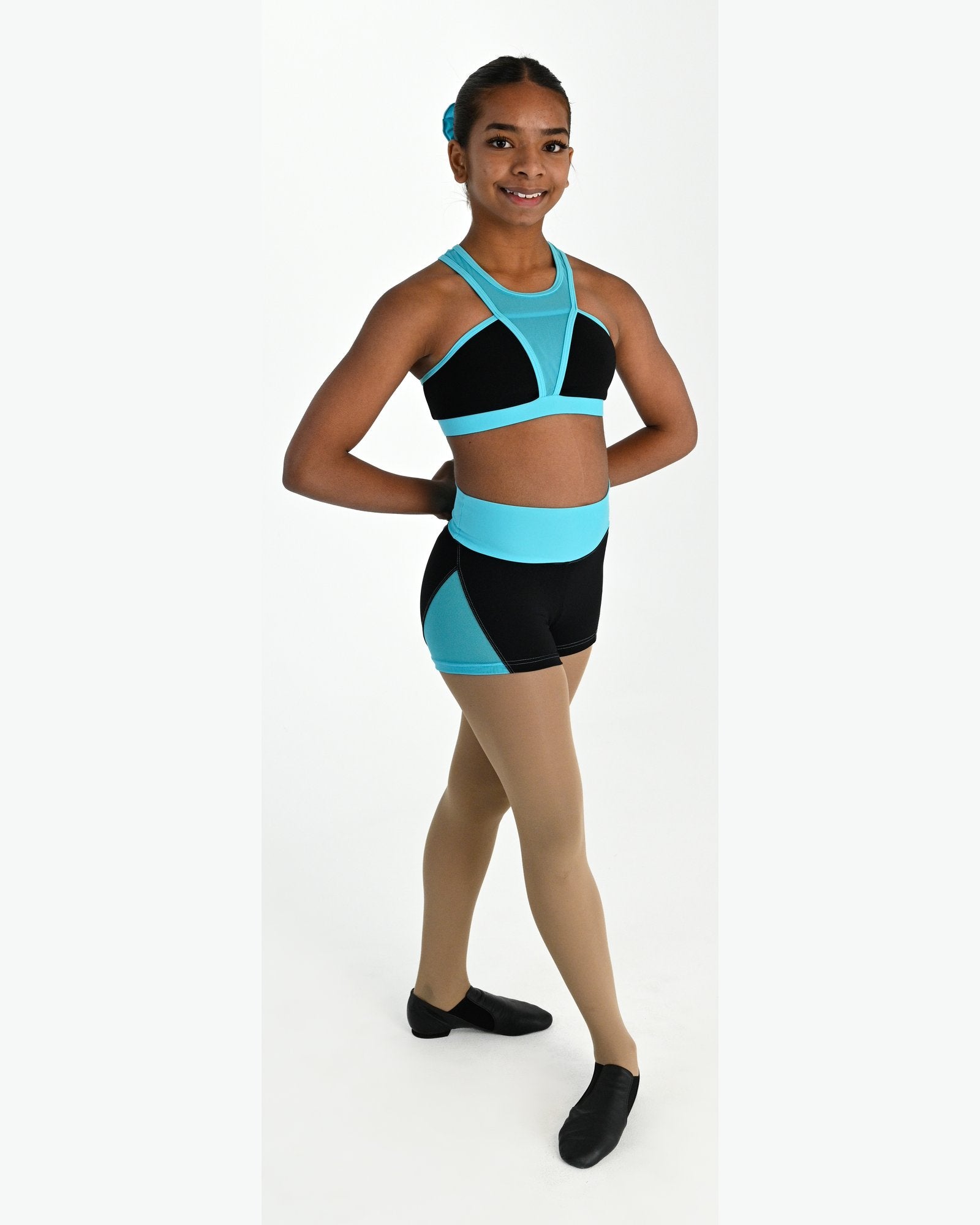 Young dancer wearing the Electra crossover racerback dance crop top in Lagoon