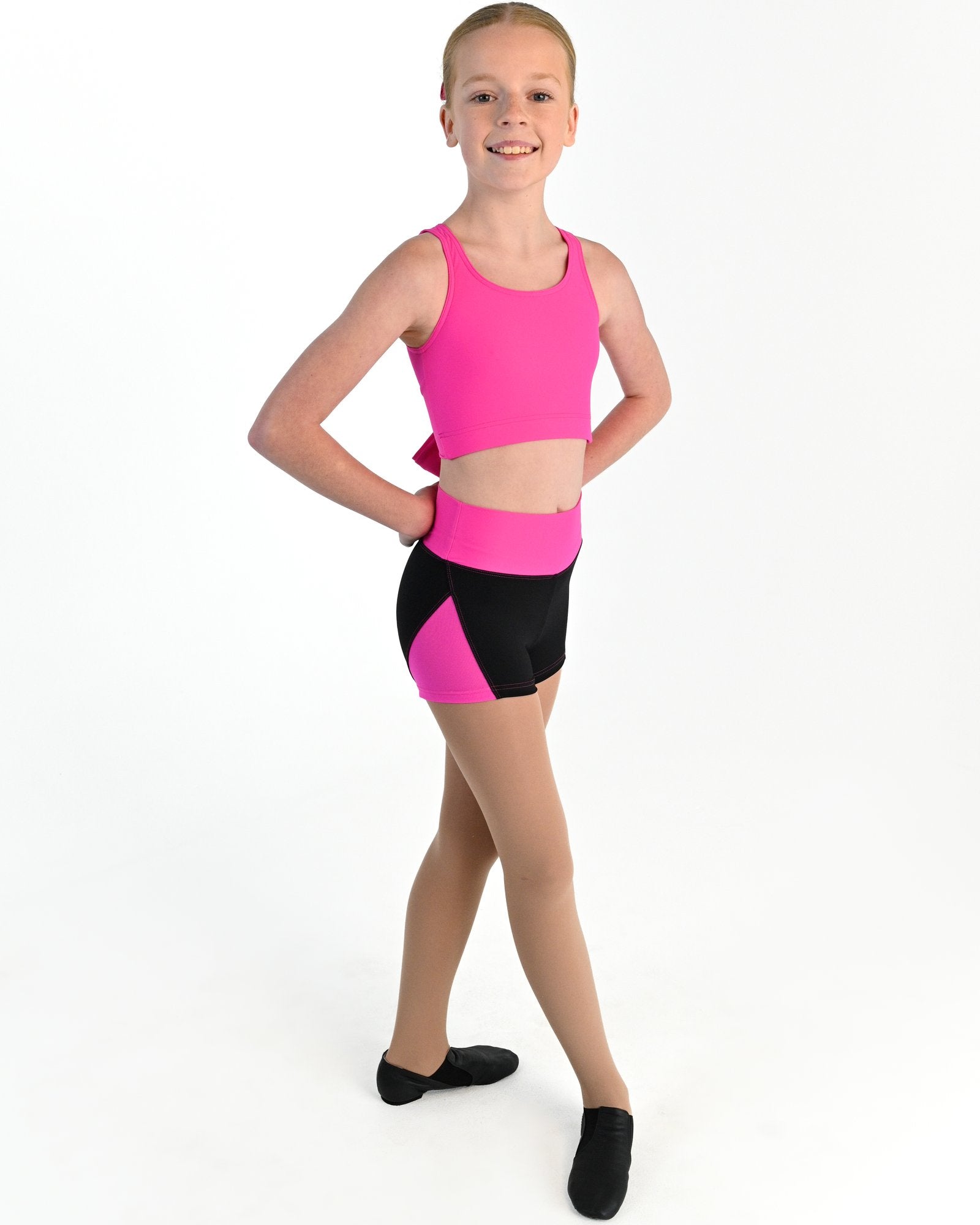 Young dancer wearing the Electra mesh panel high waisted dance shorts in Electric Pink