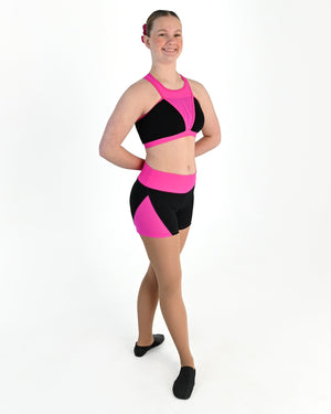 Young dancer wearing the Electra mesh panel high waisted dance shorts in Electric Pink, alternate view