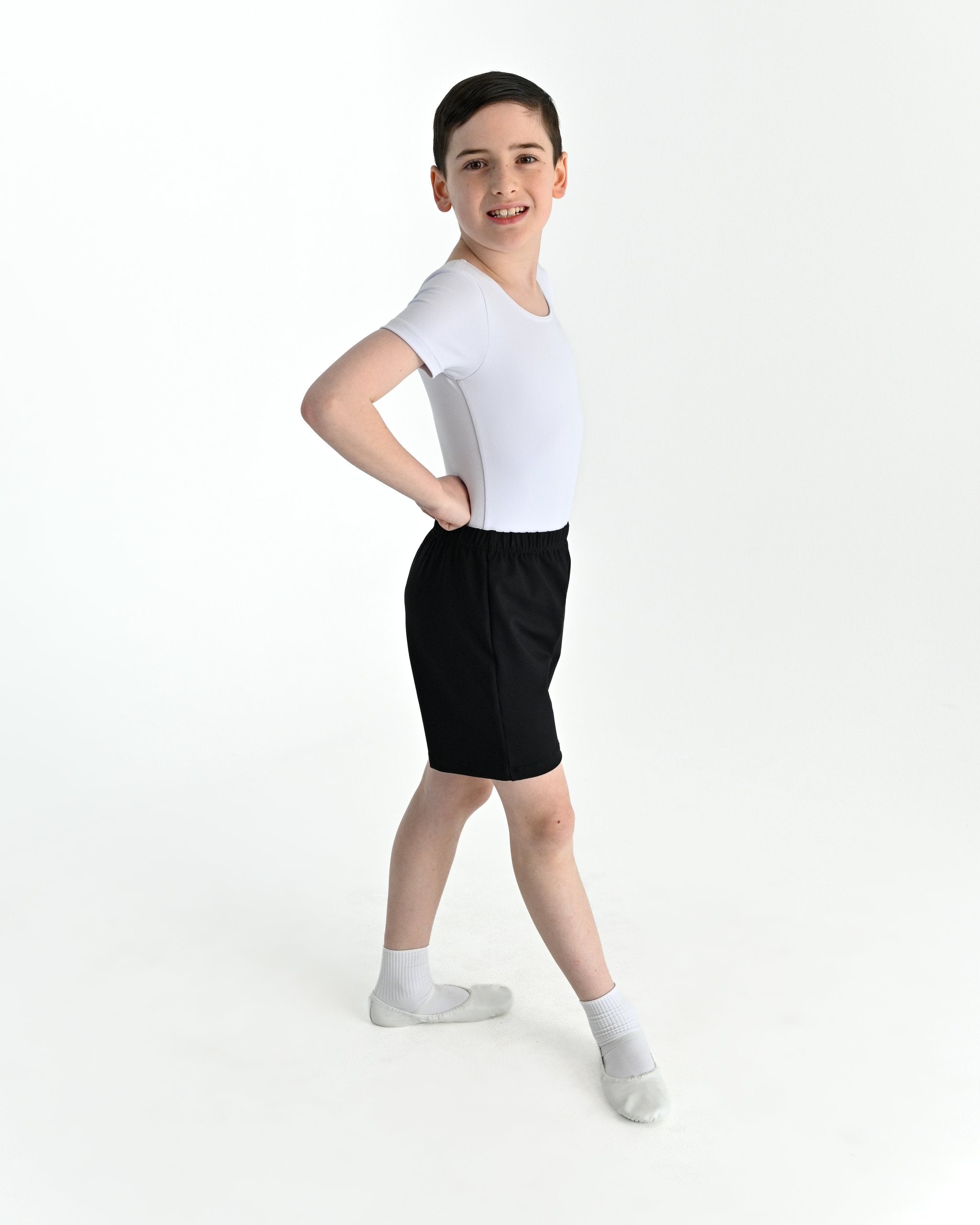 Young dancer wearing the Essential Boys Basic Dance Shorts in Black