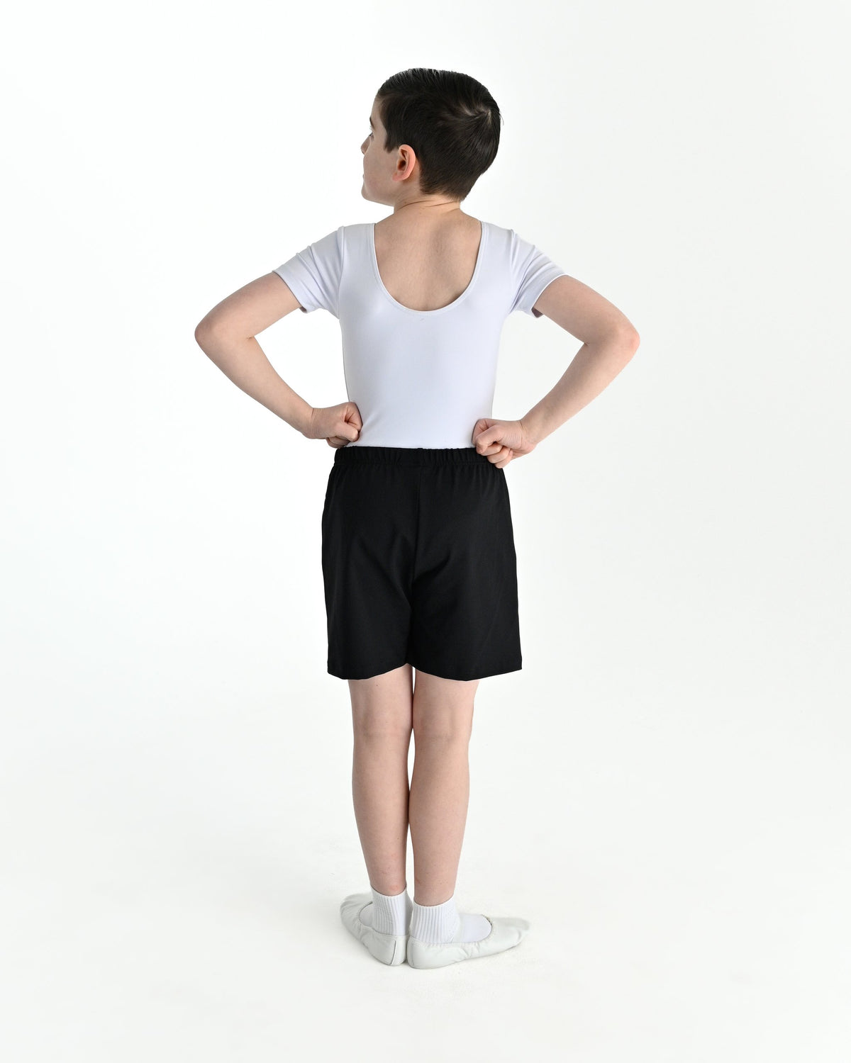 Young dancer wearing the Essential Boys Basic Dance Shorts in Black, alternate view