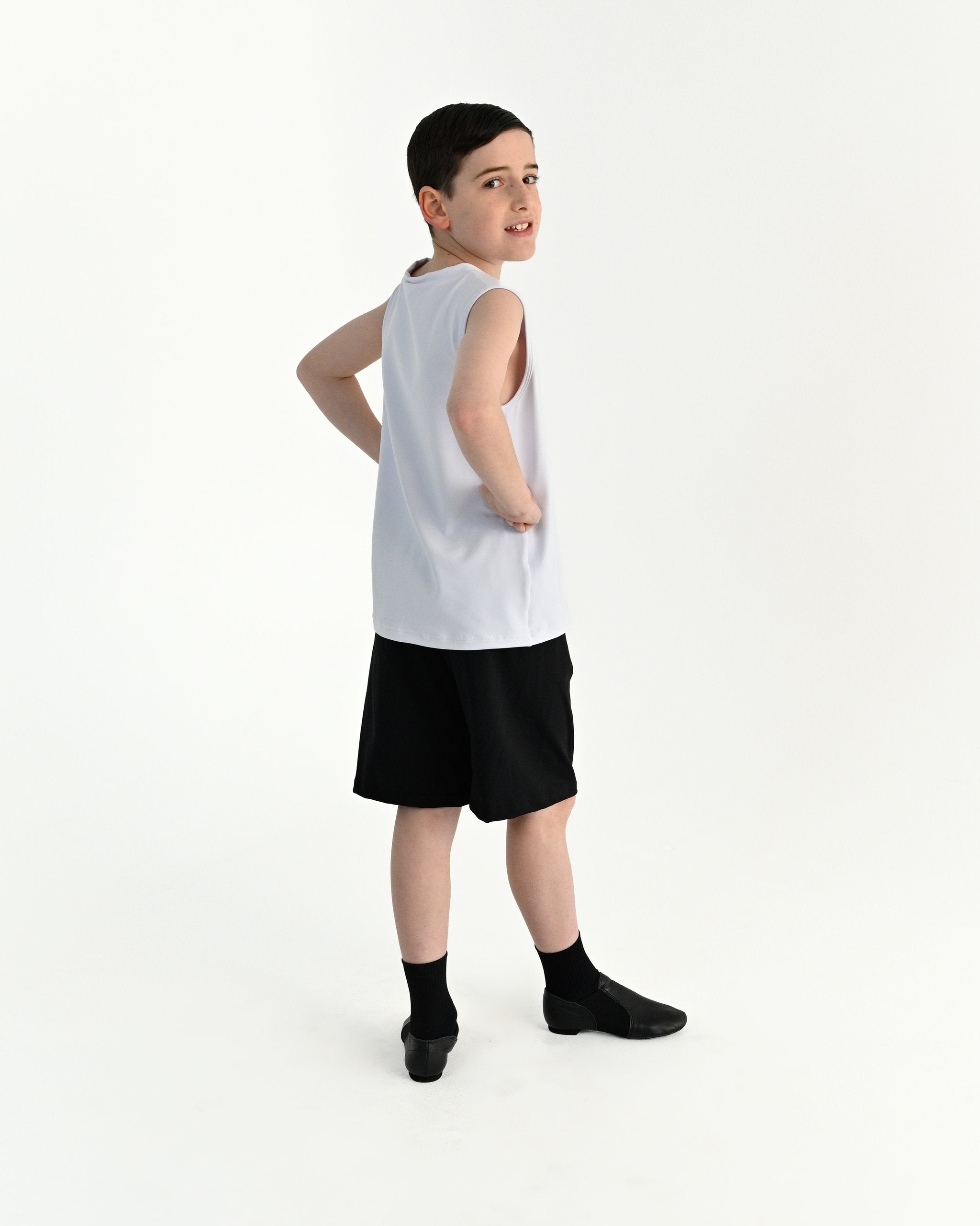 Young dancer wearing the Essential Boys Casual Dance Shorts in Black, alternate view