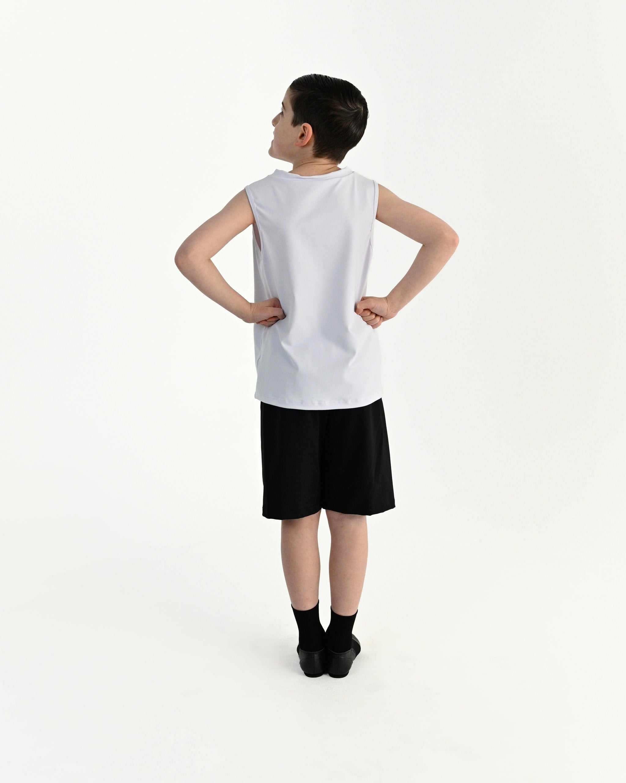 Young dancer wearing the Essential Boys Casual Dance Shorts in Black, alternate view
