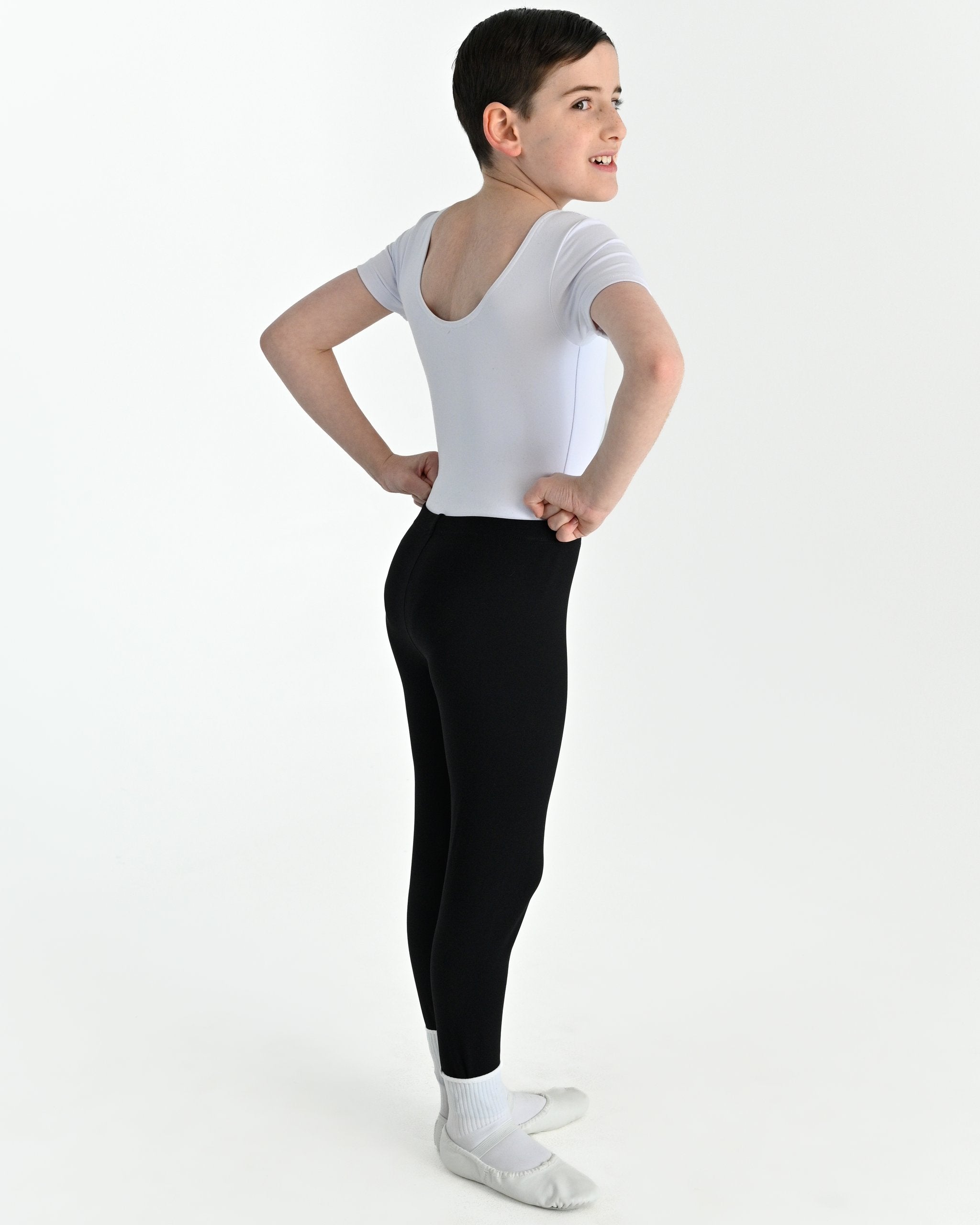 Young dancer wearing the Essential Boys Dance Leggings in Black, alternate view