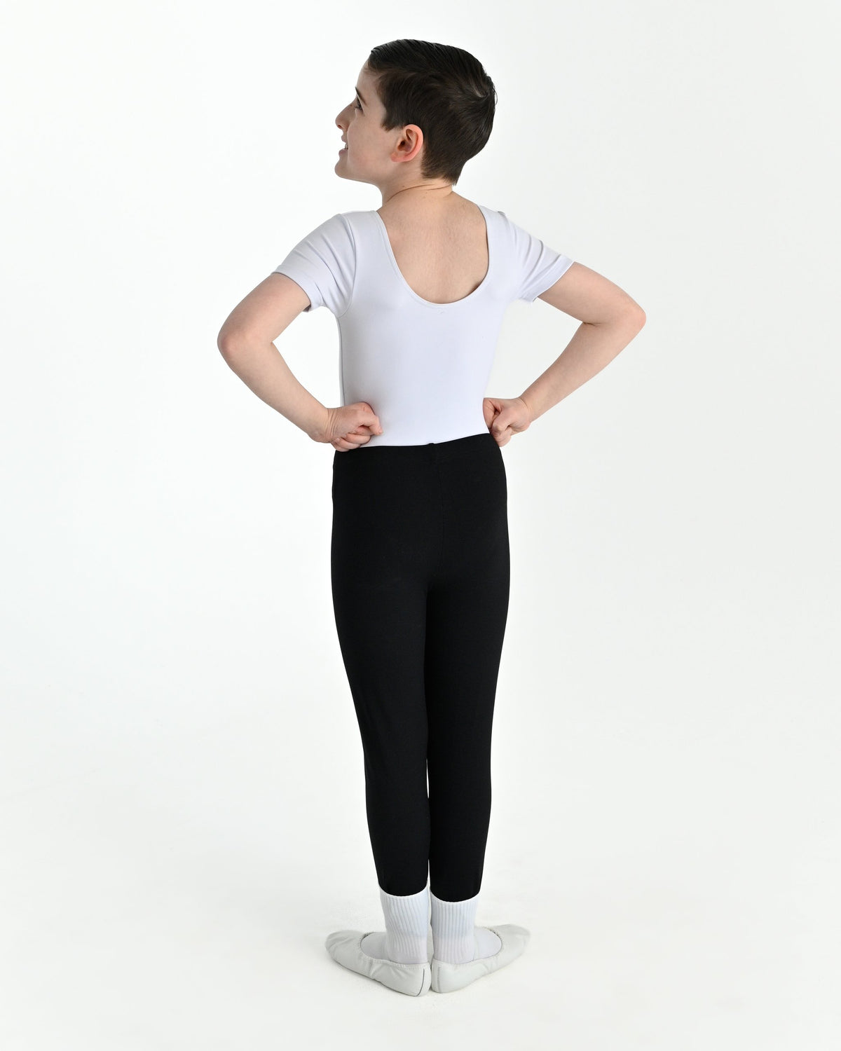 Young dancer wearing the Essential Boys Dance Leggings in Black, alternate view
