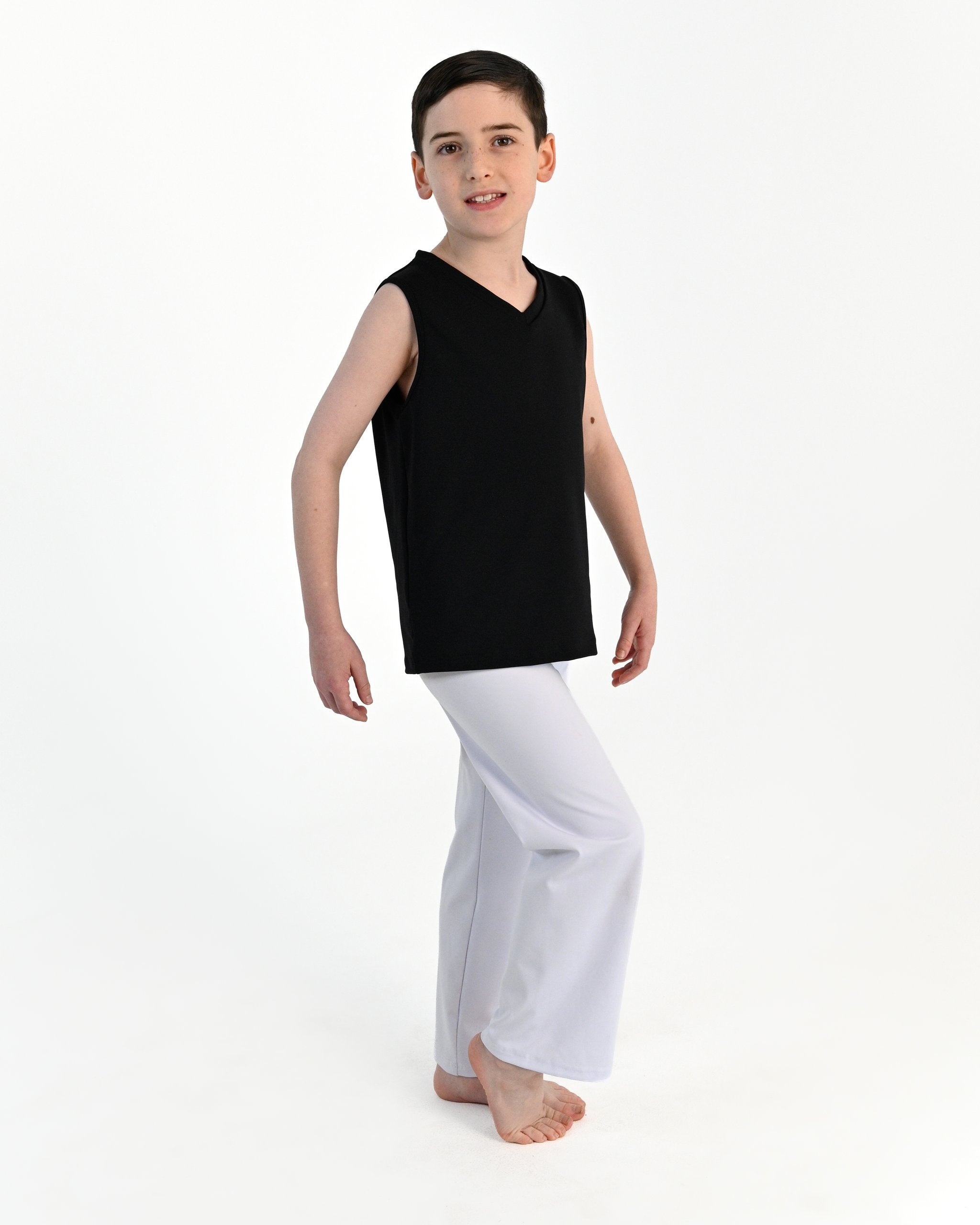 Young dancer wearing the Essential Boys Dance Tank in Black, alternate view