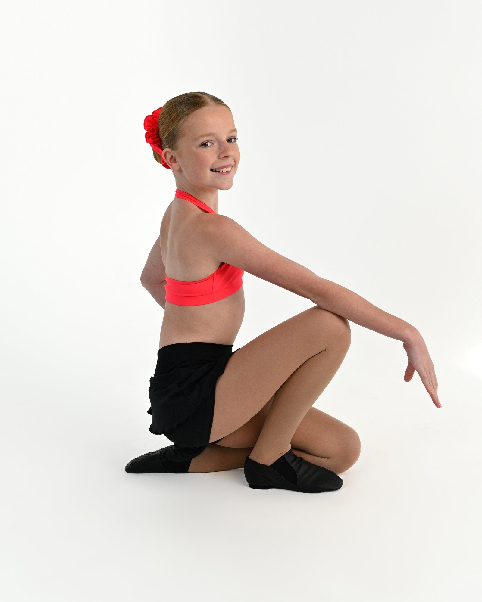 Young dancer wearing the Mila dance skort with fitted shorts underneath in Black, alternate view