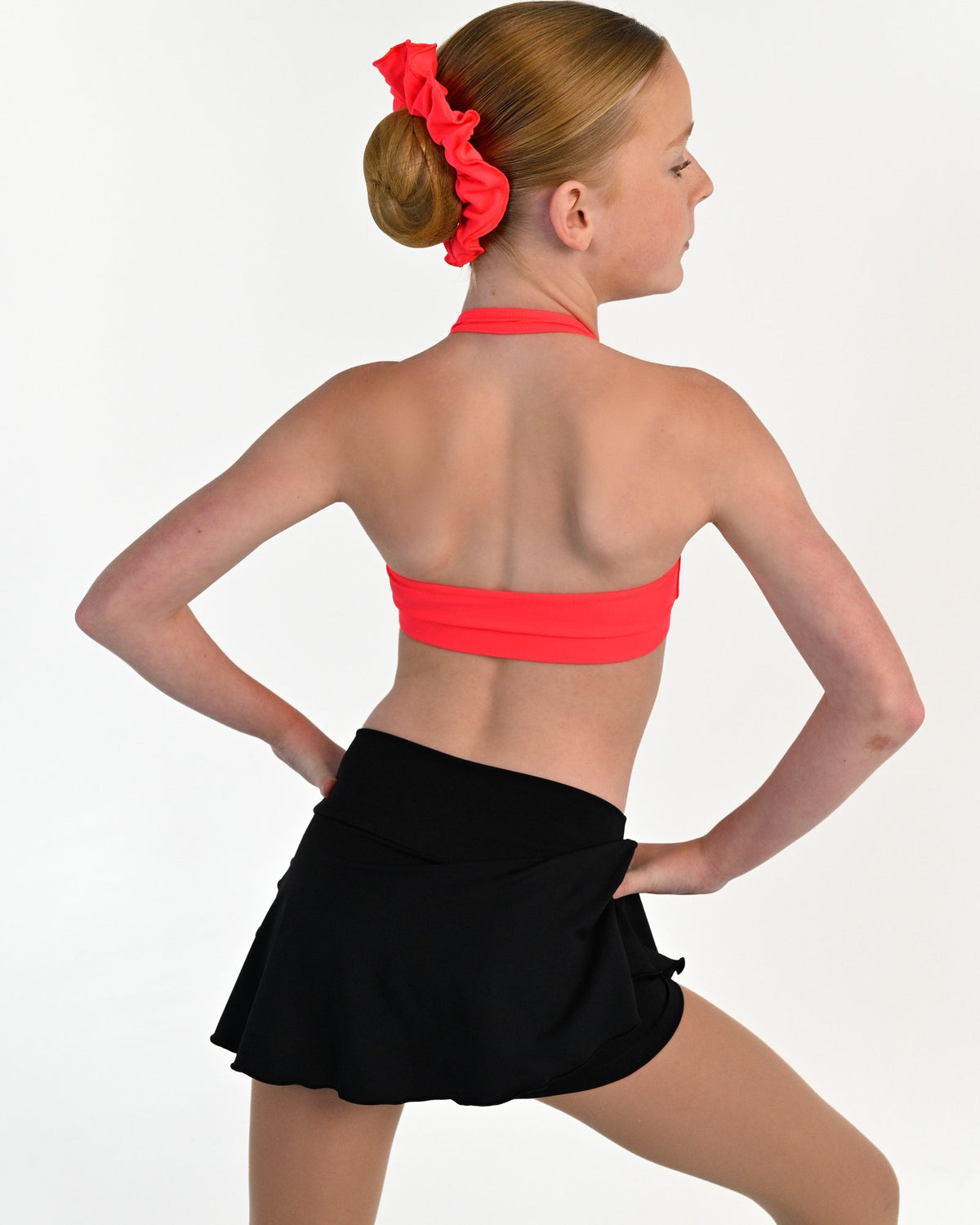 Young dancer wearing the Mila dance skort with fitted shorts underneath in Black, alternate view