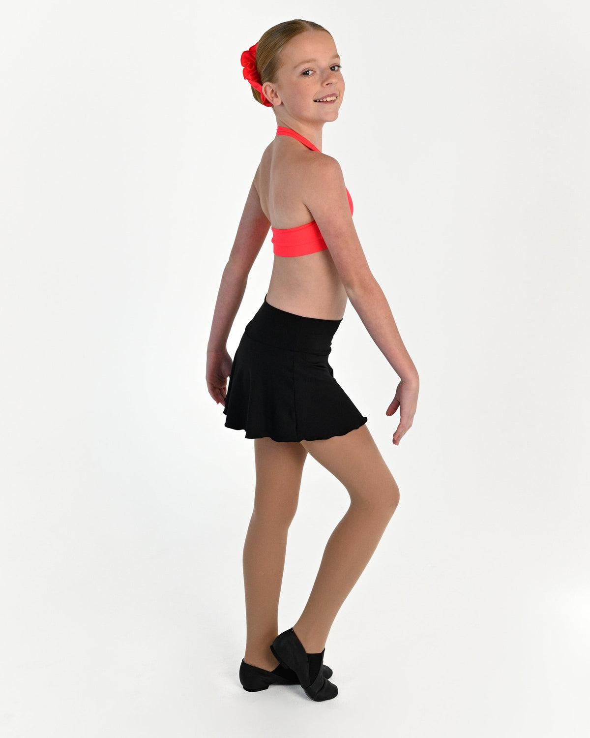 Young dancer wearing the Mila dance skort with fitted shorts underneath in Black, alternate view