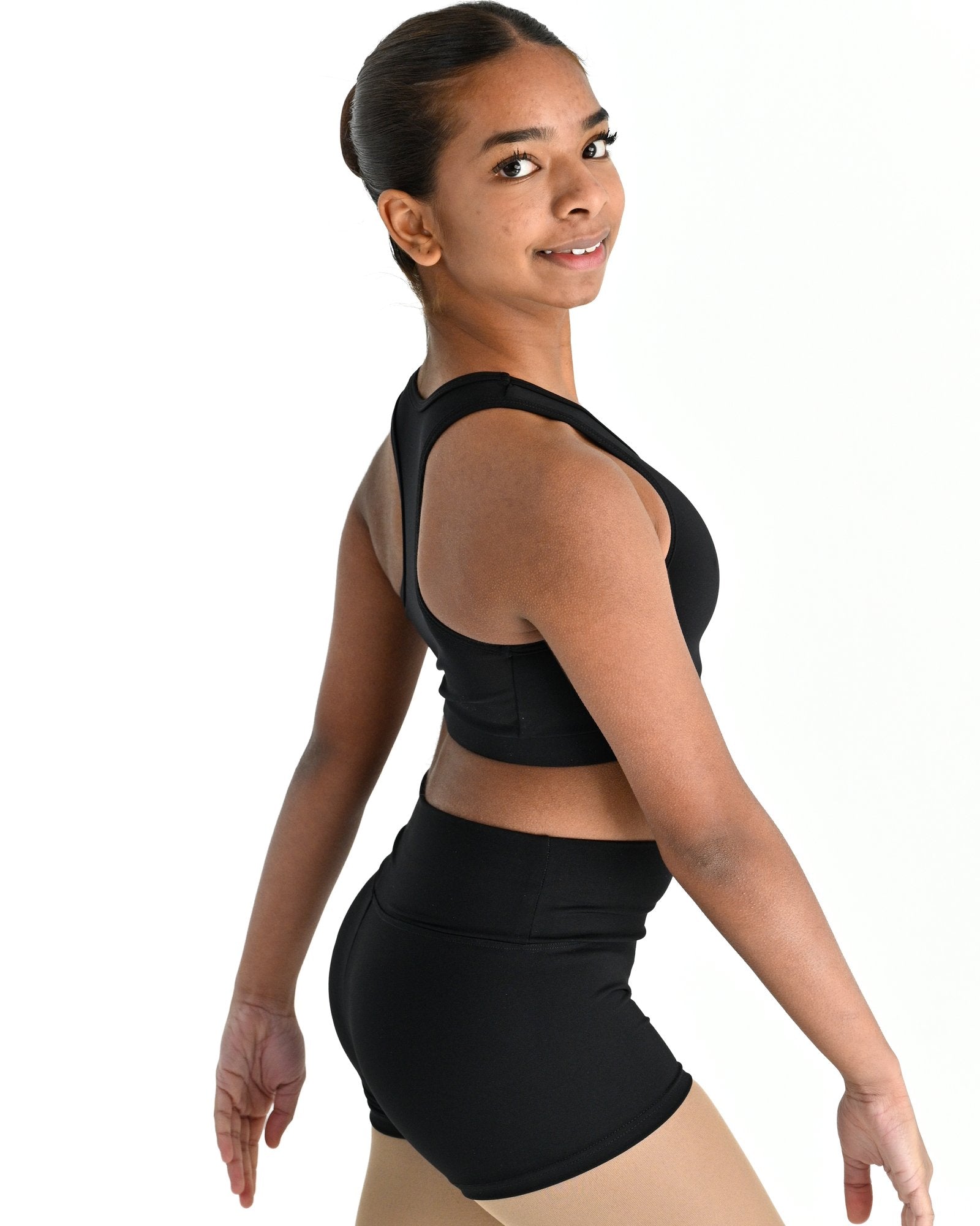 Young dancer wearing the Onyx power mesh racerback dance crop top in Black, alternate view