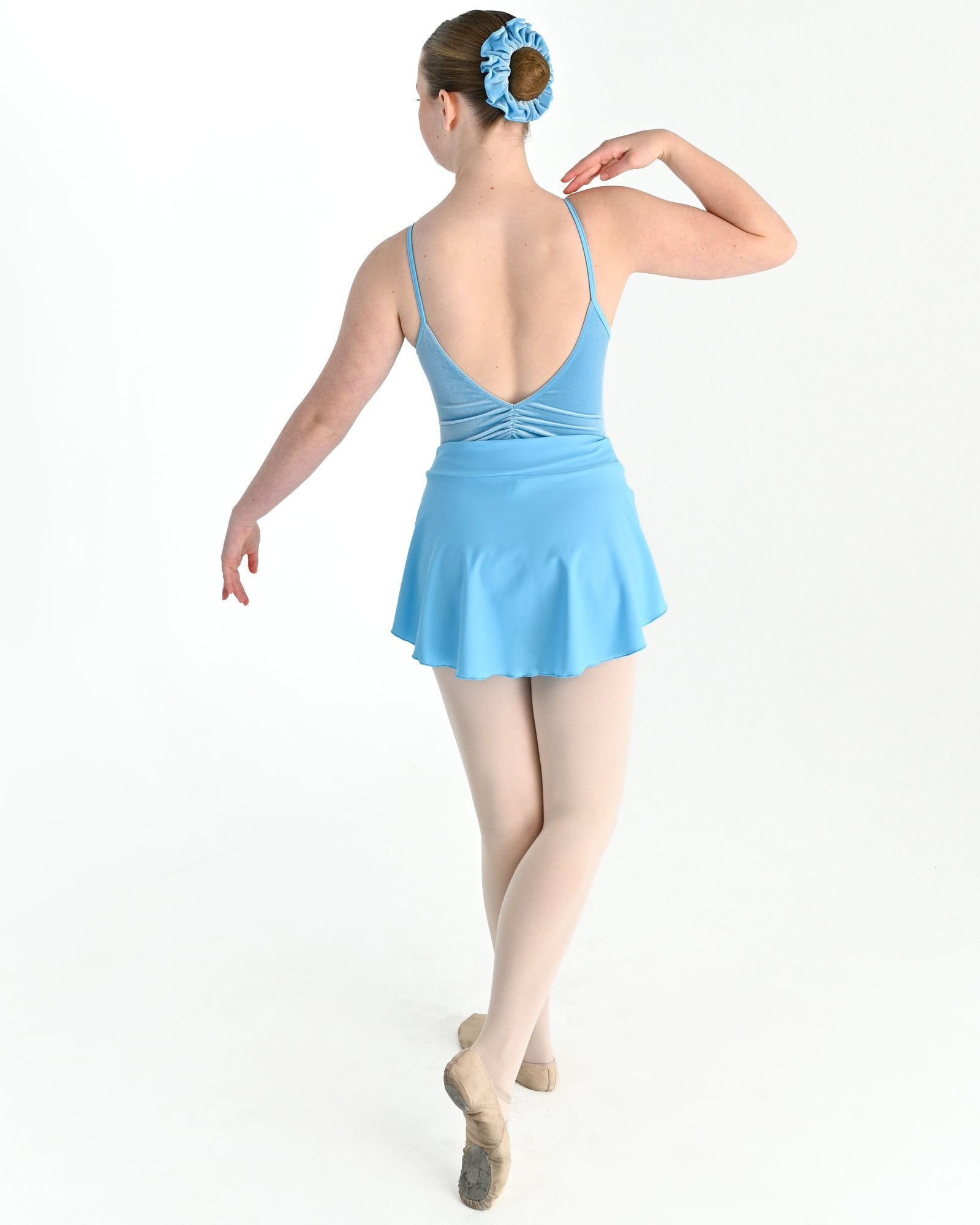 Young dancer wearing the Prima high low pull on ballet skirt in Blue, alternate view