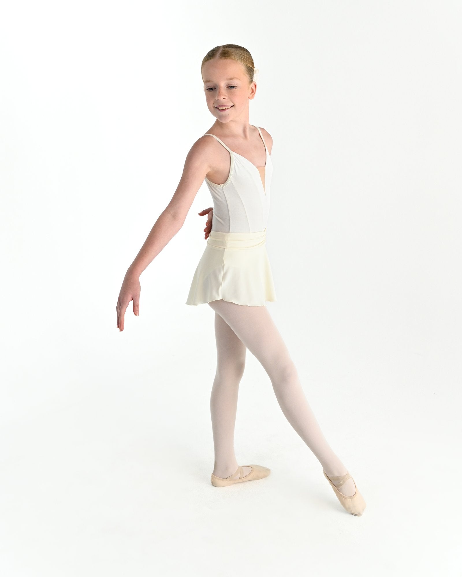 Young dancer wearing the Prima high low pull on ballet skirt in Ivory