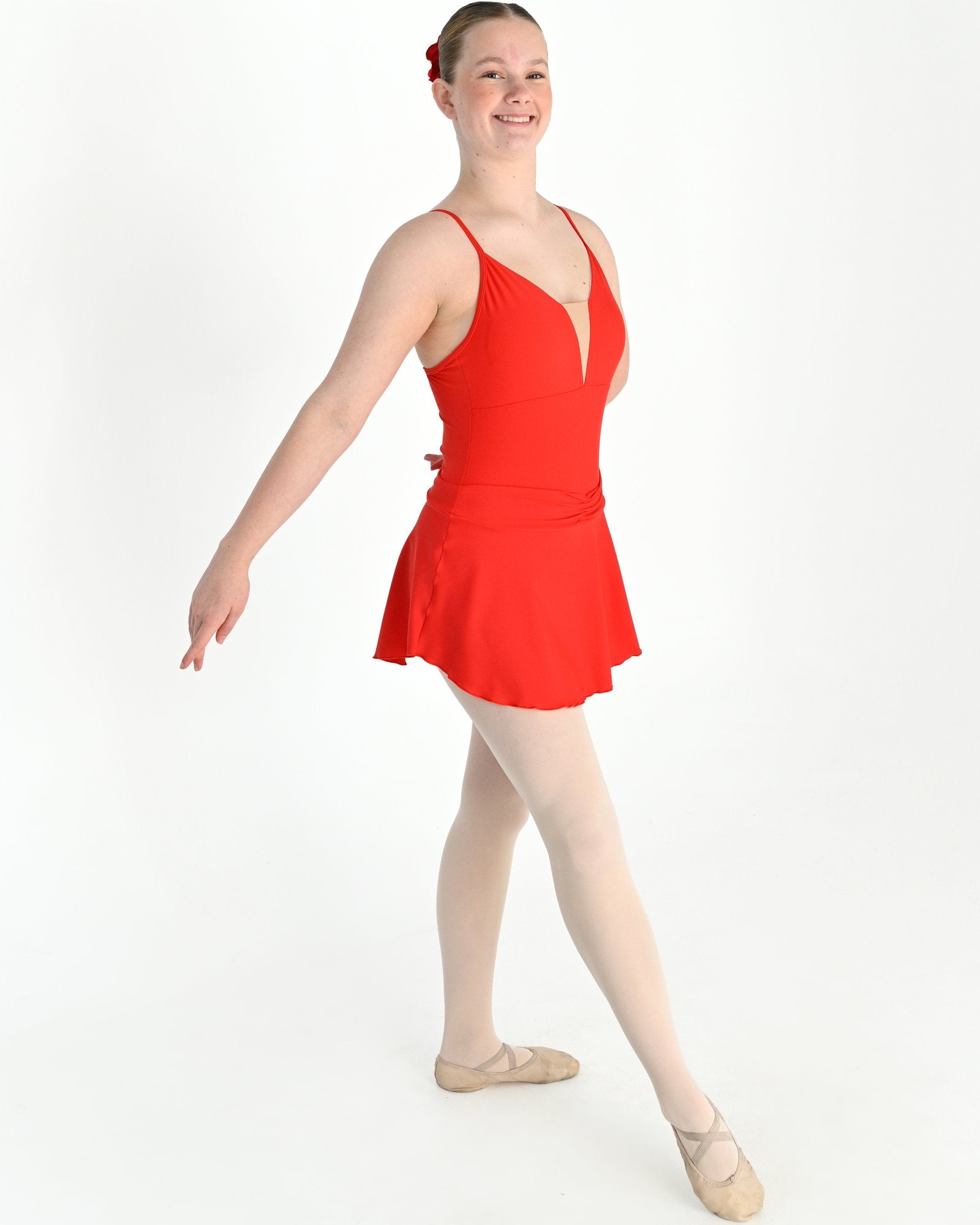 Young dancer wearing the Prima high low pull on ballet skirt in Red