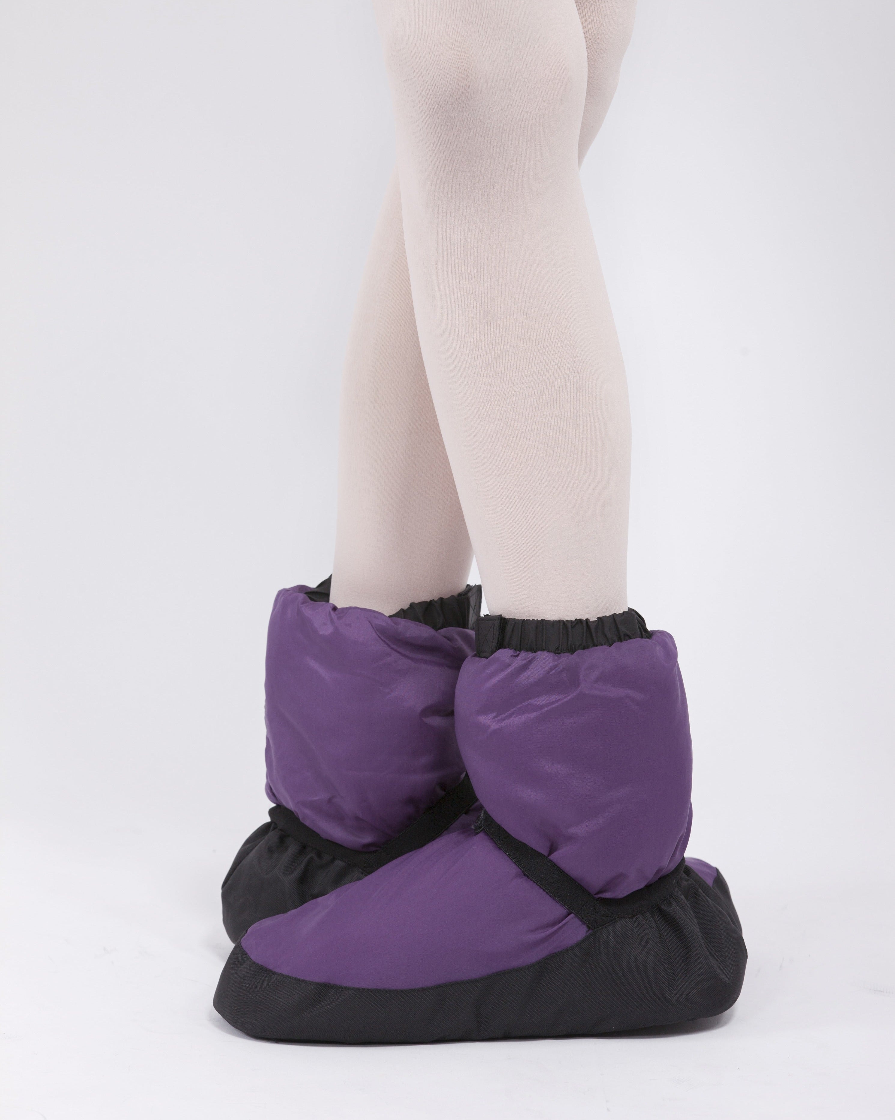 Purple warm up dance booties worn over ballet tights