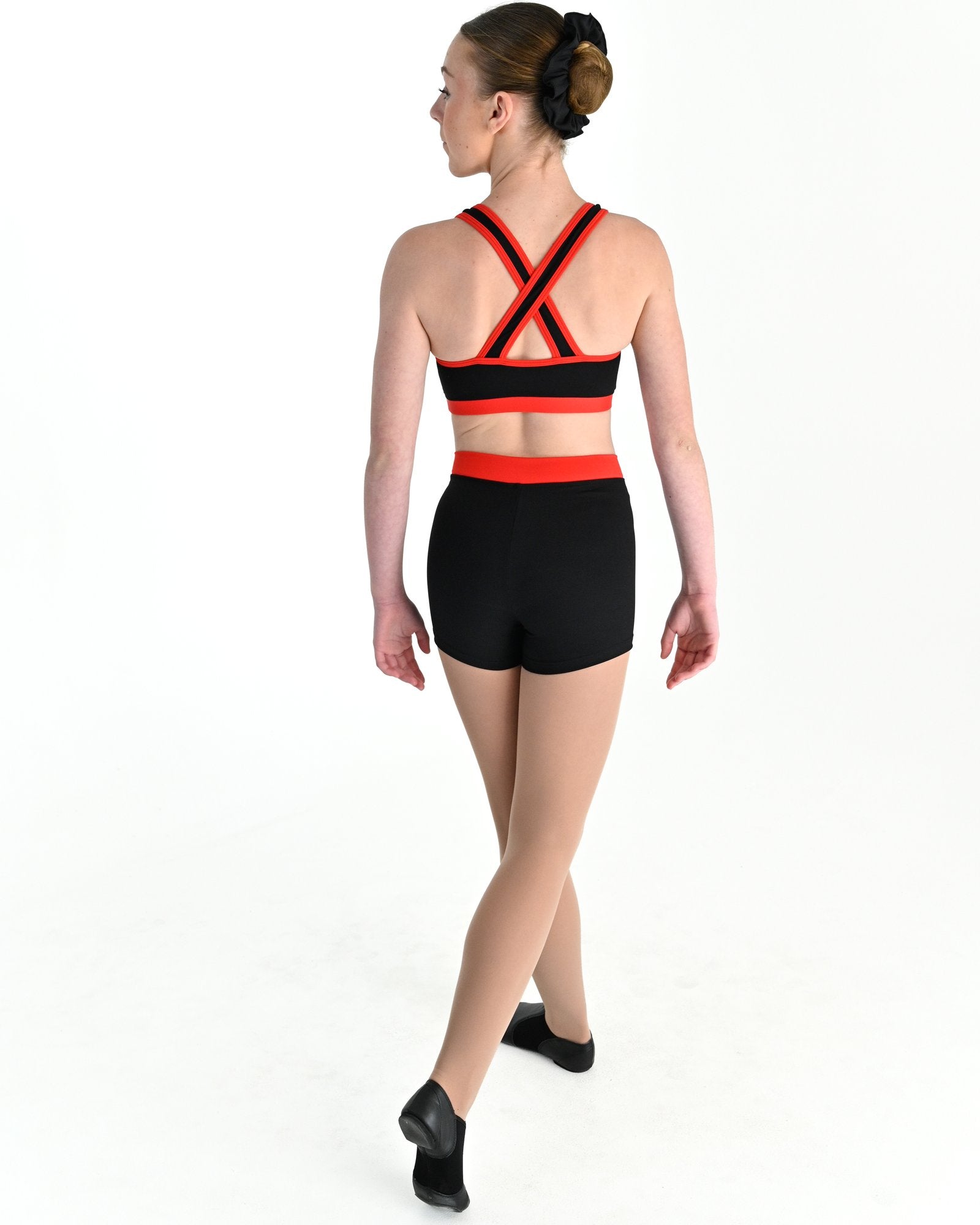 Young dancer wearing the Violet crossed back dance crop top with contrast binding in Red, alternate view